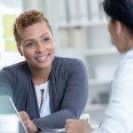 Confident African American business woman meets with colleague